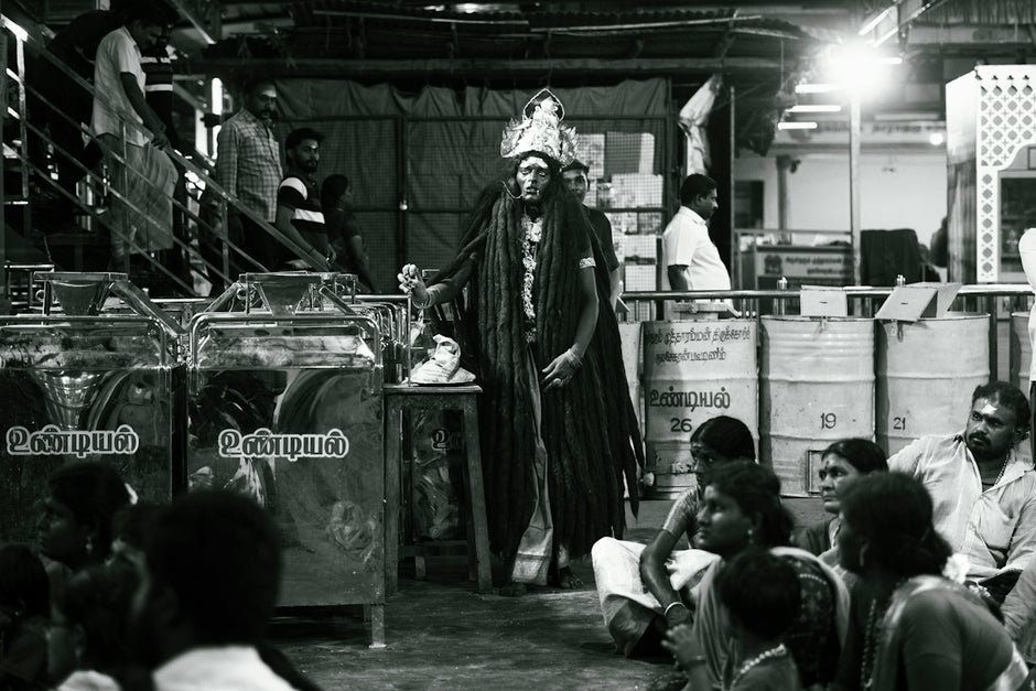 A black and white photo of people in a warehouse